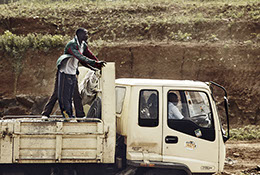 Man riding a yellow construction truck in Nairobi, Kenya